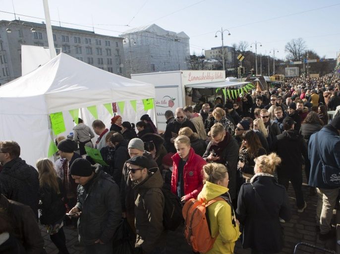 People attend the new street food initiative Streat Helsinki at the Marquet Square, in central Helsinki, Finland, 22 March 2014. Streat Helsinki is all about street food. The festival aims to praise and pioneer the opportunities and potential of street food in the city, as well as spreading the word abroad. EPA/PEKKA SIPOLA FINLAND OUT