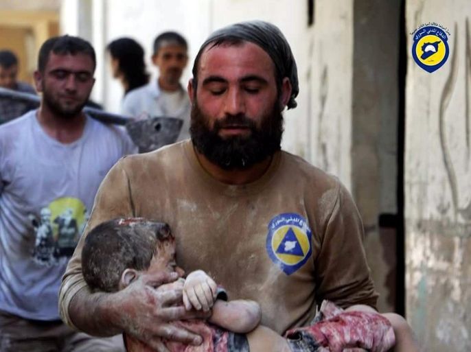 An undated handout picture made available by the Syria Civil Defence volunteer organization on 07 October 2016 showing a volunteer carrying a child victim in Aleppo, Syria. Syria Civil Defence is a volunteer group, also known as the White Helmets, that consists of over three thousand local volunteers spread across areas of conflict around Syria. In the past three years they saved over 62 thousand Syrian lives, while losing 145 volunteer during airstrikes and 430 others