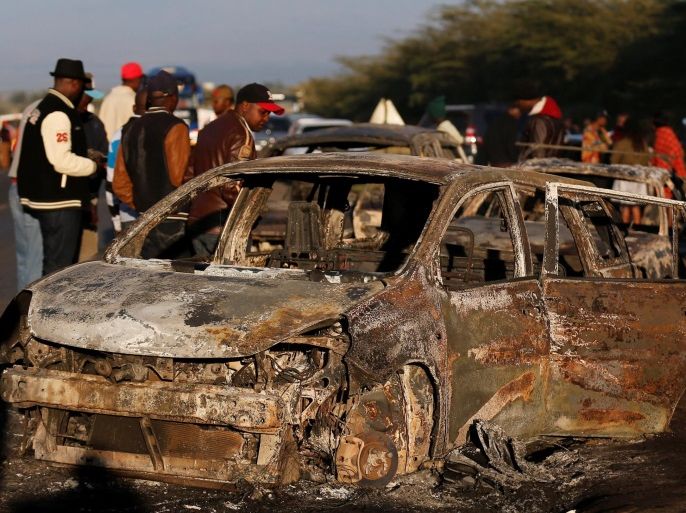 Relatives and civilians look at the wreckages of cars burnt after a fireball from an tanker engulfed several vehicles and killed several people, near the Rift Valley town of Naivasha, west of Kenya's capital Nairobi, December 11, 2016. REUTERS/Thomas Mukoya