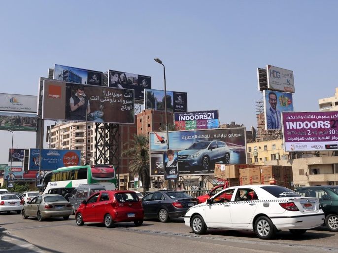 The newly rebranded 'Orange' billboard (L) in the streets of Cairo, Egypt, 22 March 2016. Orange Egypt is formerly known as Mobinil, one of three telecommunication companies in Egypt and is host of 33.5 million mobile user. Mobinil has been acquired by by the french telecommunication company Orange in 2015 and was fully rebranded starting March this year.
