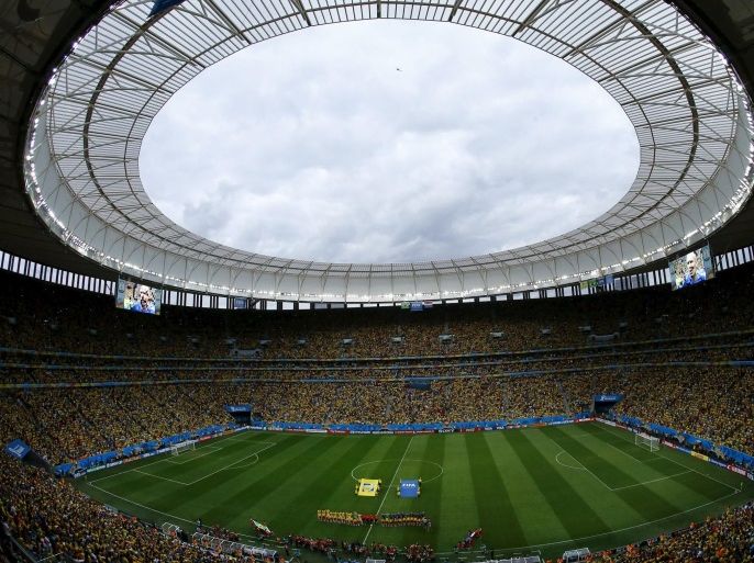 A general view of the stadium is seen as the national anthems are sung before the start of the 2014 World Cup third-place playoff between Brazil and the Netherlands at the Brasilia national stadium in Brasilia in this July 12, 2014 file photo. In the midst of Brazil's deepening economic crisis, its cash-strapped capital may not have the money to fulfill a promise to host Olympic soccer games next year, leaving unused the most expensive stadium built for the 2014 World Cup. The Rio 2016 organizing committee has given Brasilia until mid-November to sign a contract or be stripped of the seven games set to be held there next year, a spokesperson said. Tickets for matches in Brasilia have already been on sale for months and it remains unclear how fans, many of whom may have bought flights and booked hotels, would be reimbursed. Soccer games for the Olympics in Rio de Janeiro next year are set to be played in six cities across the country to make use of venues built for the World Cup. REUTERS/Ruben Sprich/Files