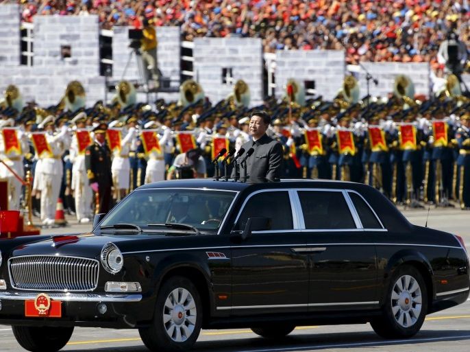 Chinese President Xi Jinping stands in a car on his way to review the army as military band members play next to him, at the beginning of the military parade marking the 70th anniversary of the end of World War Two, in Beijing, China, September 3, 2015. REUTERS/Damir Sagolj