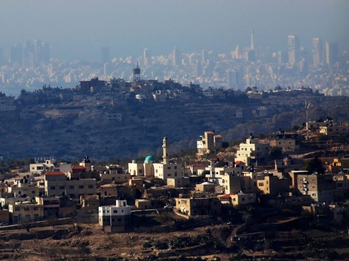A general view of two Palestinian villages in the front and Israeli City of Tel Aviv in the background, near the west bank city of Ramallah, 10 December 2016.
