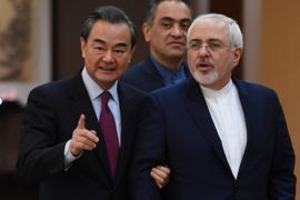 Iranian Foreign Minister Mohammad Javad Zarif (R) arrives with his Chinese counterpart Wang Yi for a joint news conference in Beijing, China December 5, 2016. REUTERS/Greg Baker/Pool