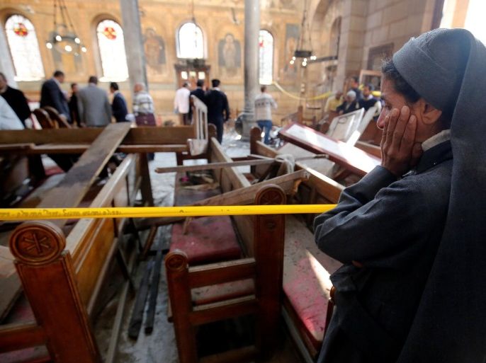 A nun cries as she stands at the scene inside Cairo's Coptic cathedral, following a bombing, in Egypt December 11, 2016. REUTERS/Amr Abdallah Dalsh