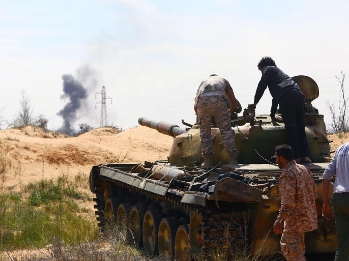 A Libyan militia in command of a tank clashes with rivals near Bir al-Ghanam, 90 km north of Tripoli, Libya, 19 march 2015. According to local reports one member of a militia blew himself up in clashes which claimed the lives of nine and left 14 wounded from both sides, as fighting continues in the war torn country, in which a senior commander from a group which has pledged allegiance to the group calling themselves the Islamic State (IS), Tunisian Ahmed Rouissi, was ki