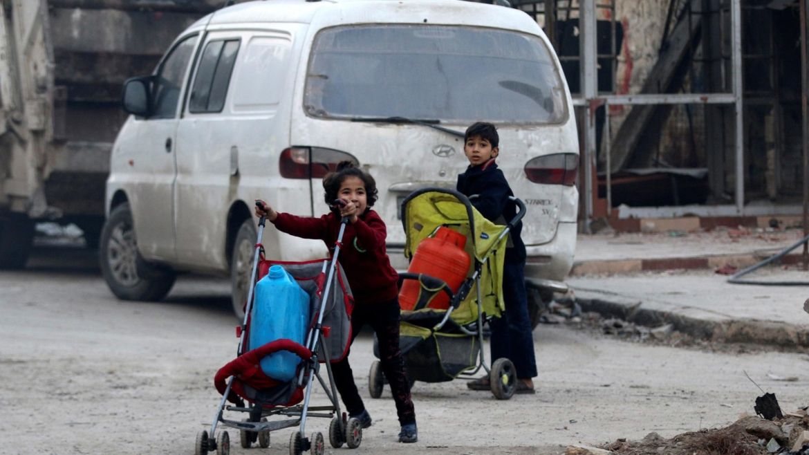 Children push containers in strollers as they flee deeper into the remaining rebel-held areas of Aleppo, Syria December 12, 2016. REUTERS/Abdalrhman Ismail