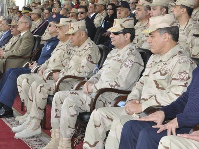 Egypt's army chief Field Marshal Abdel Fattah al-Sisi (3rd R) watches a ceremony to mark the end of the basic military training preparation period for college students and military academics at the military college in Cairo, in this March 4, 2014 handout provided by Egypt's Ministry of Defence. Sisi has sent the clearest signal yet that he will run for president, saying he cannot ignore the demands of the "majority", the state news agency MENA reported on Tuesday. REU