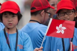 Schoolchildren wave Chinese and Hong Kong flags while waiting for the Rio Olympic Games Mainland Olympians delegation on the apron of Hong Kong International Airport in Hong Kong, China, 27 August 2016. China’s Olympic medallists landed in Hong Kong marking the start of a three-day visit to the city.