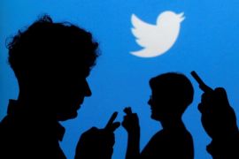 FILE PHOTO -- People holding mobile phones are silhouetted against a backdrop projected with the Twitter logo in this illustration picture taken in Warsaw September 27, 2013. REUTERS/Kacper Pempel/Illustration/File Photo