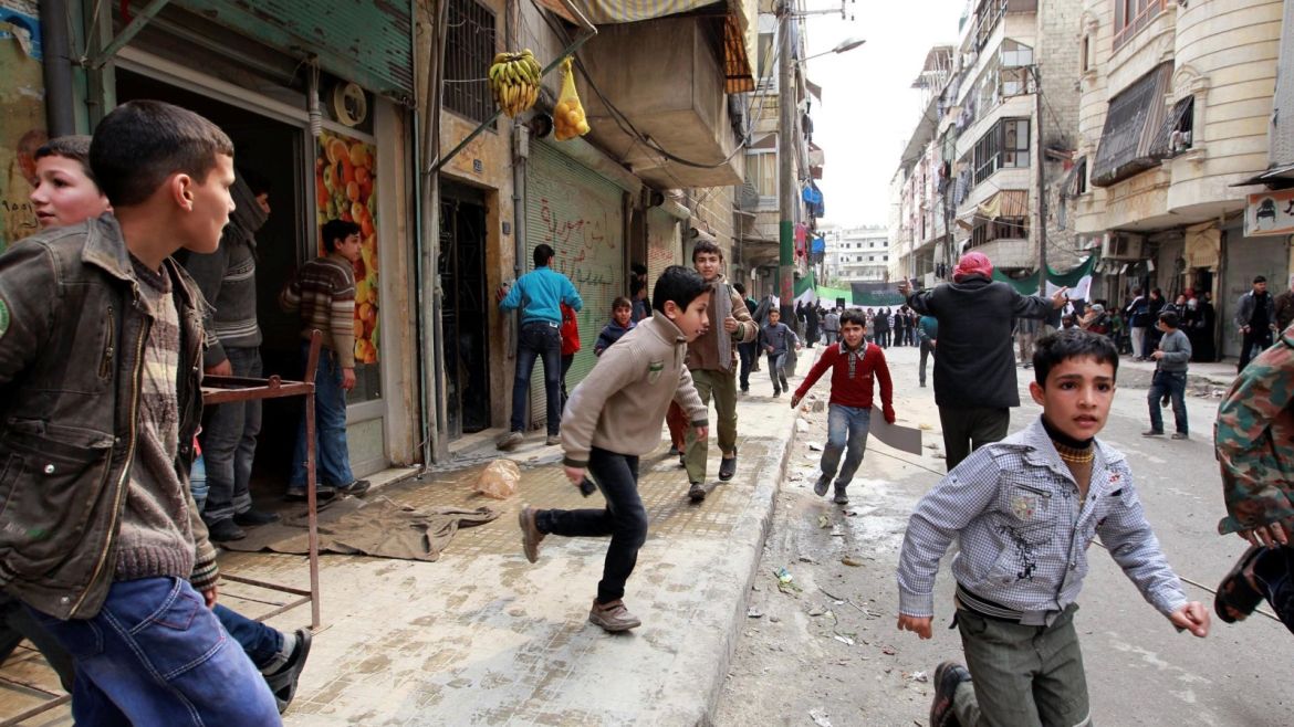 People run upon hearing a nearby plane bombing during a protest against Syrian President Bashar al-Assad in the al-Katerji Tariq district in Aleppo February 22, 2013.  REUTERS/Muzaffar Salman   SEARCH "ALEPPO TIMELINE" FOR THIS STORY