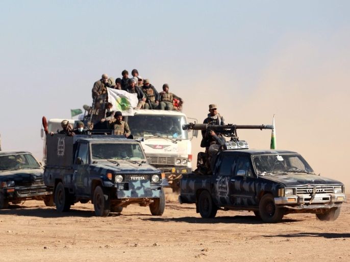 Members of Iraqi Shiite Badr Army militia on their way to take part in a military operation near Tal Afar military airport, near the town of Talafer some 40 km western Mosul, northern Iraq on 20 November 2016. The mainly Shiite groups which also known as Hashd al-Shaabi (popular crowd) announced it has encircled the city of Tal Afar from south and west, after its forces recaptured the city’s airport from the (IS) militants.