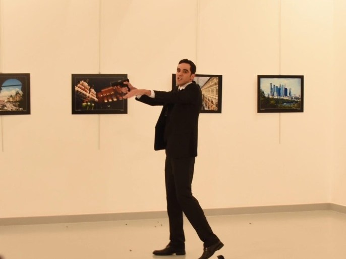 Gunman (C) stands near slain Russia's ambassador to Turkey, Andrey Karlov's body (down) after he shot him during an art exhibition in Ankara, Turkey, 19 December 2016. Russia's ambassador to Turkey, Andrey Karlov, has been shot at an art exhibition in the Turkish capital of Ankara. Karlov has died of his wounds after the attack, Russia's Ministry of Foreign Affairs confirmed. EPA/STR TURKEY OUT