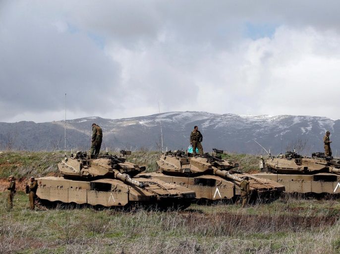 Israeli soldiers stand atop tanks in the Golan Heights near Israel's border with Syria March 19, 2014. REUTERS/Ronen Zvulun/File Photo