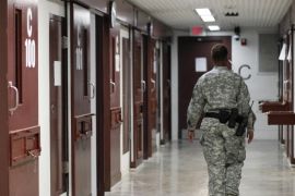A guard walks through a cellblock inside Camp V, a prison used to house detainees at Guantanamo Bay U.S. Naval Base, in this March 5, 2013 file photo. The Pentagon is expected to unveil a long-awaited plan in November 2015 outlining how it would close the detention center at Guantanamo Bay, Cuba, despite fierce resistance in Congress to President Barack Obama's push to shutter the facility, officials say. REUTERS/Bob Strong/Files