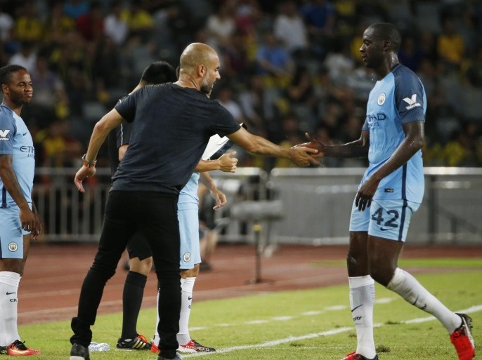Soccer Football - Borussia Dortmund v Manchester City - International Champions Cup - Longgang Stadium, Shenzhen, China - 28/7/16 Manchester City manager Pep Guardiola with Yaya Toure as he is substituted as Raheem Sterling (L) prepares to come on Action Images via Reuters / Bobby Yip Livepic EDITORIAL USE ONLY.