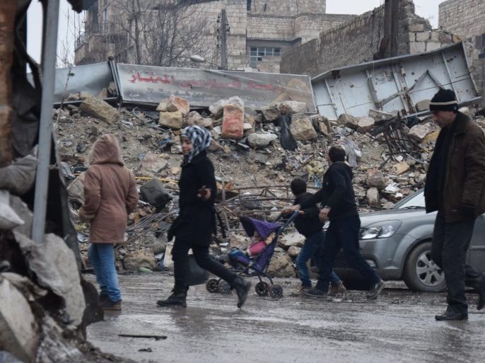 Inhabitants of the al-Kallasseh area in the eastern neighborhoods of Aleppo, Syria, carry their belongings to their temporary residence in makeshift shelters on 30 December 2016. The area, which was captured by rebel forces in 2012, was lately cleared in accordance with an agreement with the Syrian government that gave them a safe exit to the southern part of Aleppo or to Idlib province.