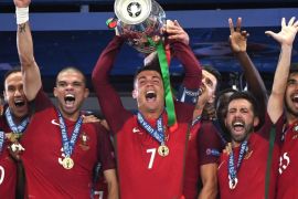 Cristiano Ronaldo (C) of Portugal lifts the trophy after winning the UEFA EURO 2016 Final match against France at Stade de France in Saint-Denis, France, 10 July 2016. (RESTRICTIONS APPLY: For editorial news reporting purposes only. Not used for commercial or marketing purposes without prior written approval of UEFA. Images must appear as still images and must not emulate match action video footage. Photographs published in online publications (whether via the Internet or otherwise) shall have an interval of at least 20 seconds between the posting.)
