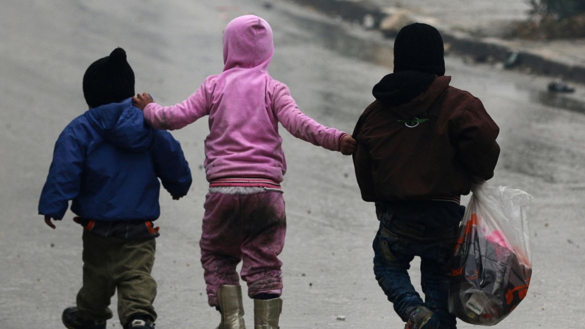 Children walk together as they flee deeper into the remaining rebel-held areas of Aleppo, Syria December 13, 2016. REUTERS/Abdalrhman Ismail