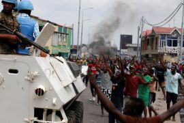 Residents chant slogans against Congolese President Joseph Kabila as peacekeepers serving in the United Nations Organization Stabilization Mission in the Democratic Republic of the Congo (MONUSCO) patrol during demonstrations in the streets of the Democratic Republic of Congo's capital Kinshasa, December 20, 2016. REUTERS/Thomas Mukoya