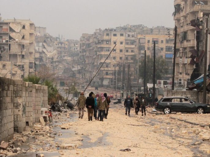 People walk at a damaged area one day after a ceasefire was announced, at al-Mashhad neighborhood in the rebel-held part of Aleppo, Syria, 14 December 2016. Syrian Observatory for Human Rights said fighting erupted around the final rebel-held area of Aleppo on 14 December as the scheduled ceasefire and mass evacuation of opposition fighters from the area stalled.