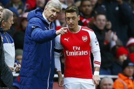 Arsenal's Mesut Ozil receives instructions from manager Arsene Wenger as he waits to come on during their English Premier League soccer match against Stoke City at the Emirates Stadium in London January 11, 2015. REUTERS/Eddie Keogh (BRITAIN - Tags: SPORT SOCCER) EDITORIAL USE ONLY. NO USE WITH UNAUTHORIZED AUDIO, VIDEO, DATA, FIXTURE LISTS, CLUB/LEAGUE LOGOS OR 'LIVE' SERVICES. ONLINE IN-MATCH USE LIMITED TO 45 IMAGES, NO VIDEO EMULATION. NO USE IN BETTING, GAMES OR SINGLE CLUB/LEAGUE/PLAYER PUBLICATIONS.FOR EDITORIAL USE ONLY. NOT FOR SALE FOR MARKETING OR ADVERTISING CAMPAIGNS.