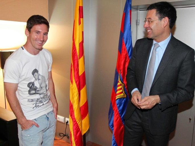 A handout picture released by FC Barcelona shows Argentinian striker Lionel Messi (L) standing next to FC Barcelona's President Josep Maria Bartomeu (R) after extending his contract in Barcelona, northeastern Spain, 19 May 2014. EPA/MIGUEL RUIZ