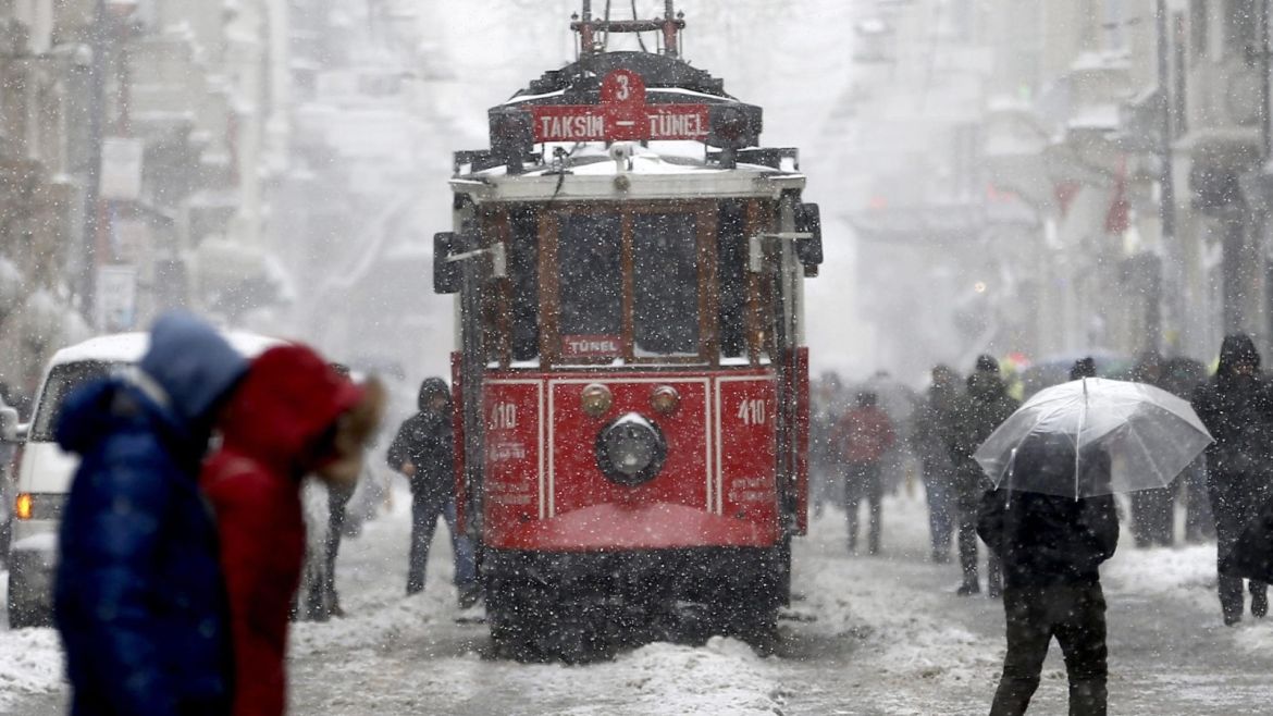 People walk on Istiklal Street while tram passing on a snowy day in Istanbul, Turkey, 07 January 2017. Temperatures in Istanbul dropped to minus five degrees Celsius with snow showers.