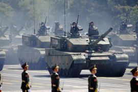 Armoured vehicles drive past paramilitary policemen during the military parade marking the 70th anniversary of the end of World War Two, in Beijing, China, in this September 3, 2015 file picture.China has almost doubled its weapons exports in the past five years, a military think tank said on Monday, as the world's third-largest weapons exporter pours capital into developing an advanced arms manufacturing industry. REUTERS/Damir Sagolj/Files