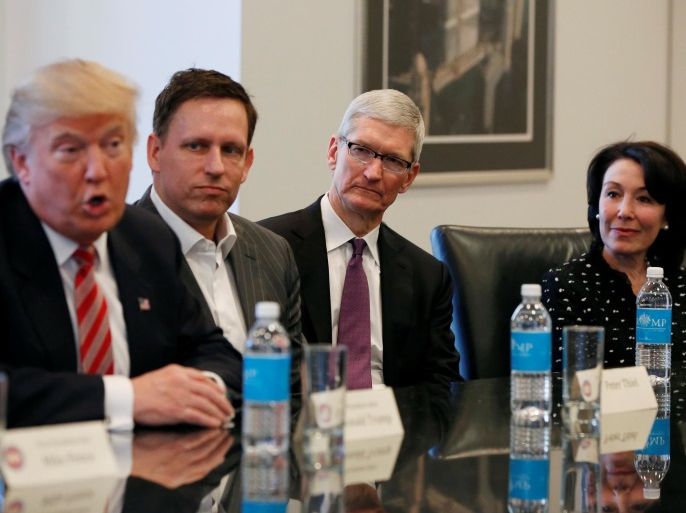 U.S. President-elect Donald Trump speaks as (2nd L to R) PayPal co-founder and Facebook board member Peter Thiel, Apple Inc CEO Tim Cook and Oracle CEO Safra Catz look on during a meeting with technology leaders at Trump Tower in New York U.S., December 14, 2016. REUTERS/Shannon Stapleton
