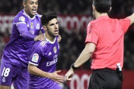 Real Madrid's forward Mariano Diaz (L) congratulates Marcos Asensio (C) after scoring against Sevilla during their 16th round of King's Cup second leg match played at Ramon Sanchez Pizjuan's stadium in Seville, Andalusia, Spain, on 12 January 2017.