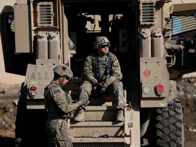 US army soldiers sit next a military vehicle in the town of Bartella, east of Mosul, Iraq, December 27, 2016. Picture taken December 27, 2016. REUTERS/Ammar Awad
