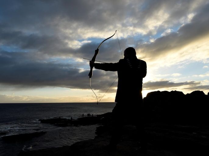 An archer prepares to fire an arrow into the sea as part of a Claiming of the Waters tradition at the 800-year-old Hook Head lighthouse in Hook Head, Ireland January 1, 2017. REUTERS/Clodagh Kilcoyne