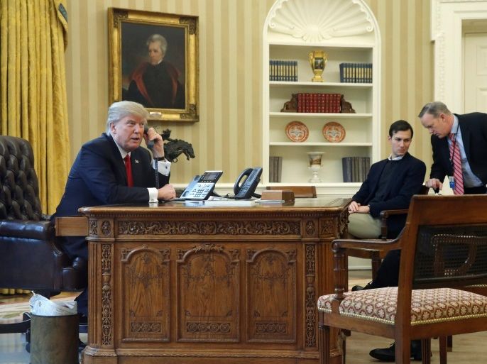 U.S. President Donald Trump, joined by senior advisor Jared Kushner (3rd R), Communications Director Sean Spicer (2nd R) and National Security Advisor Michael Flynn (R), speaks by phone with Saudi Arabia's King Salman in the Oval Office at the White House in Washington, U.S. January 29, 2017. REUTERS/Jonathan Ernst