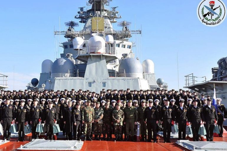 A handout photo made available by the official Syrian Arab News Agency (SANA) showing Chief of the General Staff of the Syrian Army and Armed Forces General Ali Abdullah Ayoub (C) posing for a group photo with the crew of Russian aircraft carrier Admiral Kuznetsov at the end of its mission off the Syrian coast in Tartus, Syria on 06 January 2017. According to SANA, on 06 January 2017, Russia began reducing its military presence in Syria with the withdrawal of its aircra