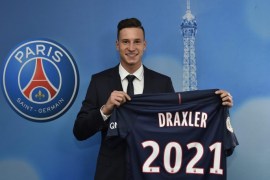 A handout photo made available by Paris Saint Germain pressroom on 03 January 2017 shows German attacking midfielder Julian Draxler posing for photographs with the PSG jersey. Julian Draxler signed on a four-and-a-half year contract.
