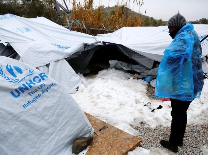 A migrant is covered with a plastic cover to protect from low temperatures as snow lays next to tents provided by the UNHCR at the refugee camp of Moria on the Greek island of Lesbos, January 10, 2017. Petros Tsakmakis/Intimenews via REUTERS ATTENTION EDITORS - THIS IMAGE WAS PROVIDED BY A THIRD PARTY. EDITORIAL USE ONLY. NO RESALES. NO ARCHIVE. GREECE OUT. NO COMMERCIAL OR EDITORIAL SALES IN GREECE