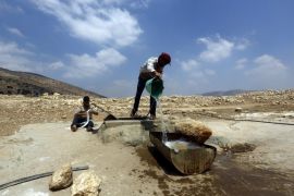 Bedouin farmer pour water from a well at Yarza Bedouin area on the outskirts of the northern West Bank city of Tubas, 08 August 2016. Local Palestinian sources reported that Israeli forces on Monday destroyed nine km of water pipes from a water network near the village of Yarza east of Tubas. The network feeds Palestinian villages and Bedouin dwellings in the northern Jordan Valley.