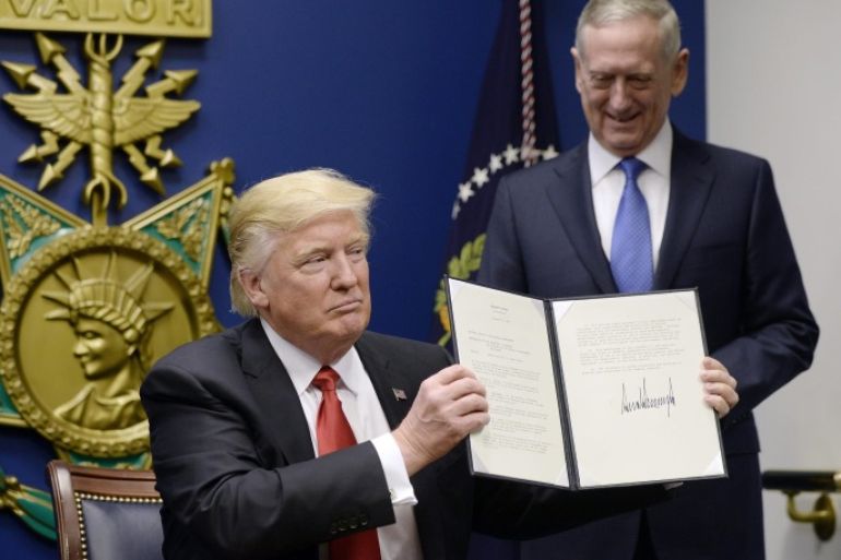 US President Donald J. Trump signs Executive Orders in the Hall of Heroes at the Pentagon in Arlington, Virginia, USA, 27 January 2017, as newly sworn-in US Secretary of Defense James Mattis (R) looks on.