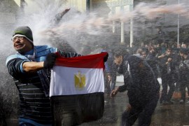 A protester holds an Egyptian flag as he stands in front of water cannons during clashes in Cairo January 28, 2011. Five years ago thousands of protesters took to the streets demanding the end of the 30-year reign of President Mubarak as Egypt became the second country to join the Arab Spring. After weeks of clashes, strikes and protests across Egypt, Mubarak resigned on February 11, 2011. REUTERS/Yannis Behrakis SEARCH "EGYPT UPRISING" FOR ALL IMAGES