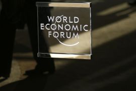 A man walks past the official logo of the World Economic Forum (WEF) in Davos, Switzerland January 16, 2017. REUTERS/Ruben Sprich