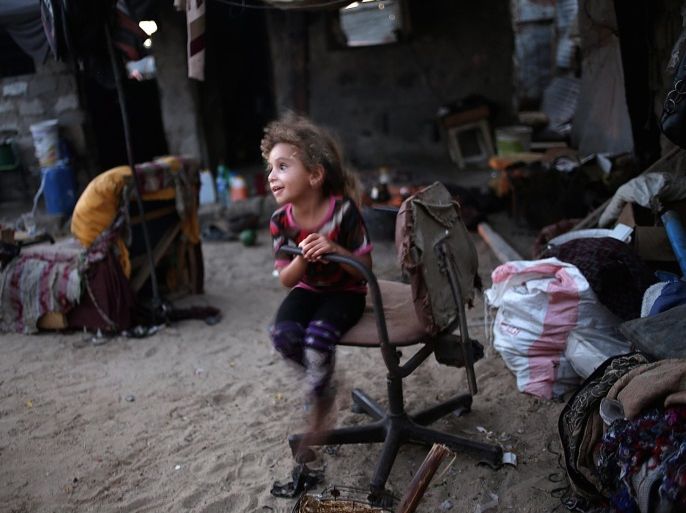 A picture made available on 24 June 2016 shows A Palestinian refugee girl play in her fmily makeshift house before the breakfast, during the eighteenth day of the holy month of Ramadan, in the south of Khan Younis refugee camp, southern Gaza Strip on 23 June 2016. More than 100 Palestinian families live in a devastating and impoverished area, known as Nahr Al-Barid, they do not have any source of income and reports of human right's instituations said that more 70 per c
