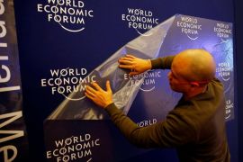 A worker prepares the logo of the World Economic Forum in the congress center of the annual meeting of the World Economic Forum (WEF) in Davos, Switzerland January 16, 2017. REUTERS/Ruben Sprich