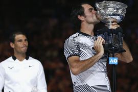 Tennis - Australian Open - Melbourne Park, Melbourne, Australia - 29/1/17 Switzerland's Roger Federer kisses the trophy after winning his Men's singles final match against Spain's Rafael Nadal. REUTERS/Issei Kato TPX IMAGES OF THE DAY