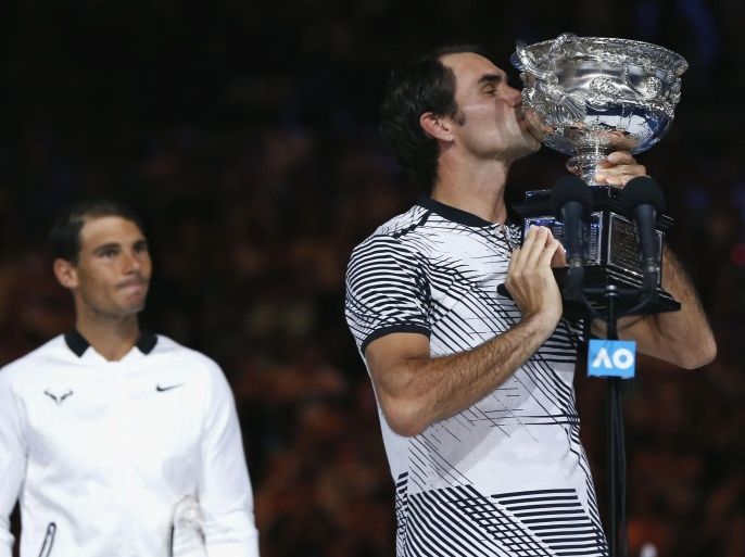 Tennis - Australian Open - Melbourne Park, Melbourne, Australia - 29/1/17 Switzerland's Roger Federer kisses the trophy after winning his Men's singles final match against Spain's Rafael Nadal. REUTERS/Issei Kato TPX IMAGES OF THE DAY