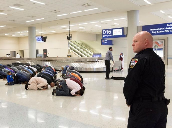 People gather to pray in baggage claim during a protest against the travel ban imposed by U.S. President Donald Trump's executive order, at Dallas/Fort Worth International Airport in Dallas, Texas, U.S. January 29, 2017. REUTERS/Laura Buckman TPX IMAGES OF THE DAY