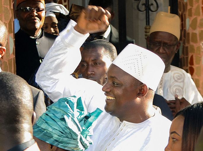 epa05731978 President-elect of Gambia Adama Barrow (C) waves to supporters after he was sworn in as president at the Gambia embassy in Dakar, Senegal, 19 January 2017. West African military forces are moving in to enforce the transfer of power removing President Yahya Jammeh following his refusal to accept election results and hand over power to President-elect Adama Barrow. EPA/STR
