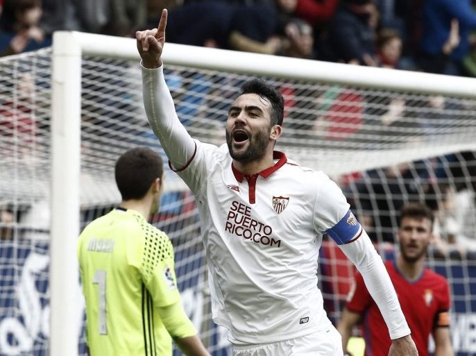 Sevilla's midfielder Vicente Iborra (C) celebrates after scoring against Osasuna during their Spanish Primera Division league match at El Sadar Stadium, in Pamplona, northern Spain, 22 January 2017.