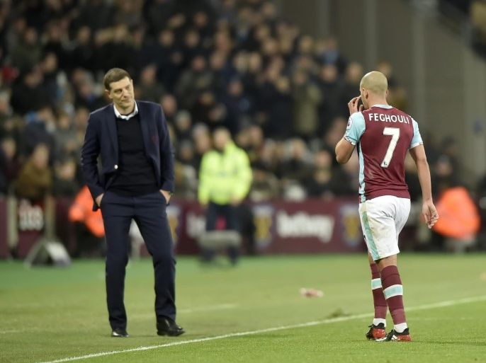 West Ham United's Sofiane Feghouli (R) walks off the pitch after being given a red card as his coach Slaven Bilic looks on during the English Premier League soccer match between West Ham and Manchester United at the The London Stadium in London, Britain, 02 January 2017.EDITORIAL USE ONLY. No use with unauthorized audio, video, data, fixture lists, club/league logos or 'live' services. Online in-match use limited to 75 images, no video emulation. No use in betting, games or single club/league/player publications