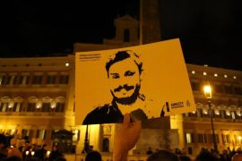 A man holds a placard during a vigil to commemorate Giulio Regeni, who was found murdered in Cairo a year ago, in downtown Rome, Italy January 25, 2017. REUTERS/Tony Gentile